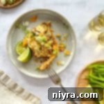 Doritos Taco Casserole on a plate with lime wedges.