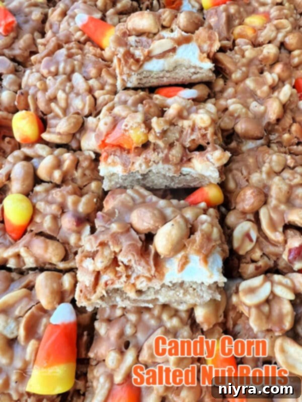 A large serving of Candy Corn Salted Nut Roll Bars on a white platter, ready to be enjoyed.