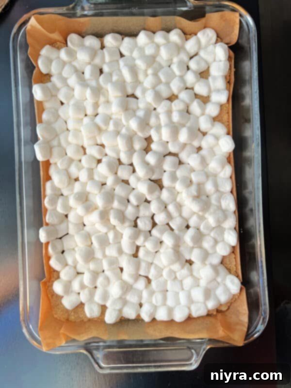 Baked crust topped with mini marshmallows, before being returned to the oven.