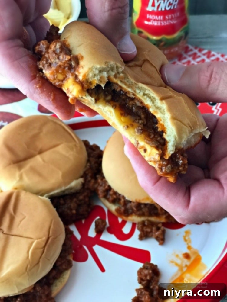 Hands holding a messy Sloppy Dorothy Sandwich