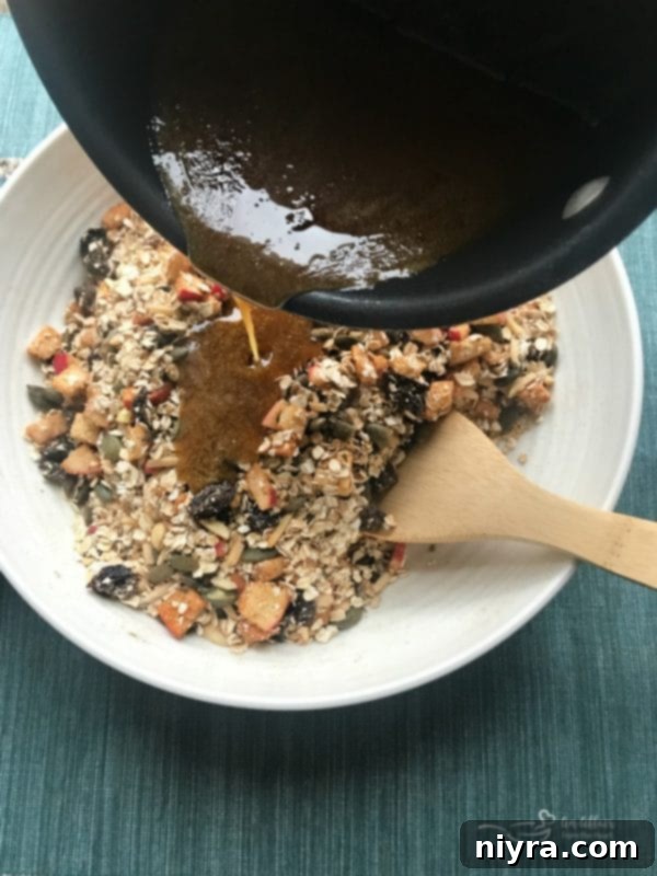 Wet Ingredients Being Poured Over Dry Ingredients for Granola