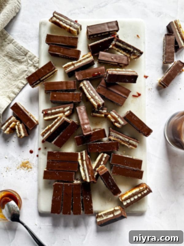 Triple Layer Chocolate Caramel Delight 2 Close-up of a perfectly layered homemade Twix bar, showing the cracker base, caramel, and chocolate-peanut butter top