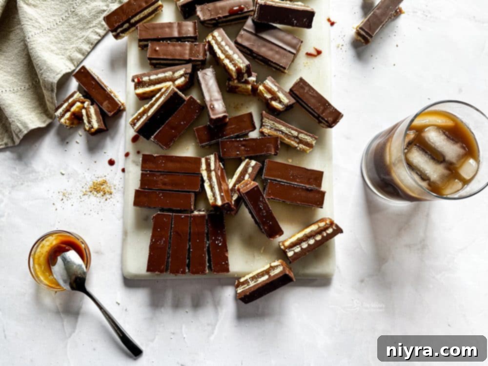 Triple Layer Chocolate Caramel Delight 16 A close-up of a generous slice of homemade Twix bar, showing the distinct layers and rich texture.