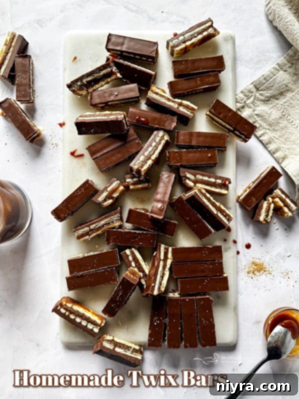 Triple Layer Chocolate Caramel Delight 18 A beautifully composed shot of homemade Twix bars, showcasing the layered texture and rich chocolate coating, perfect for a recipe hero image.