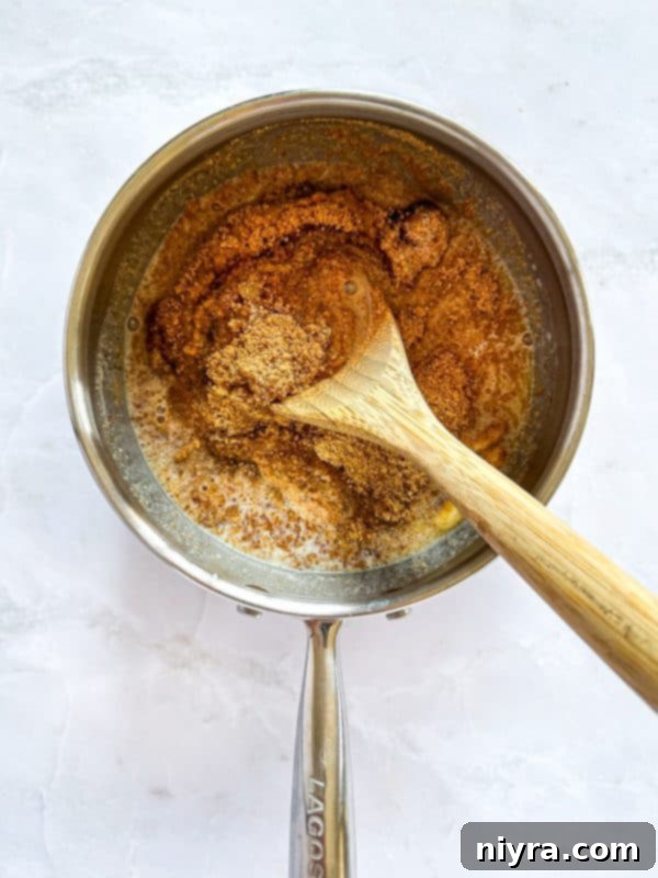 Triple Layer Chocolate Caramel Delight 6 A baking dish with a single layer of Club crackers covering the bottom, acting as the base.