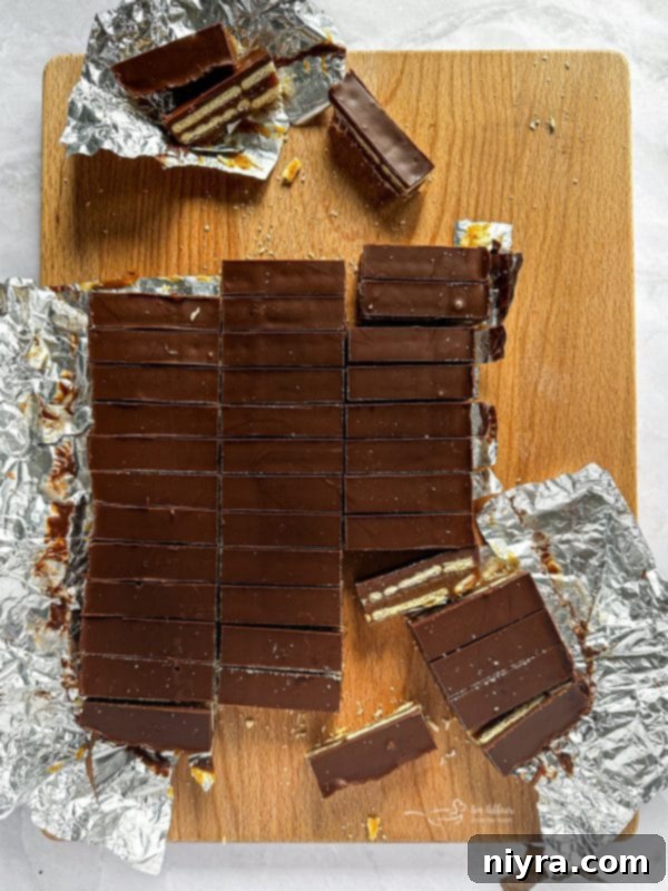 Triple Layer Chocolate Caramel Delight 10 Melted chocolate and peanut butter mixture being poured over the top layer of crackers.