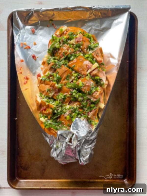 Drizzling garlic butter over crack bread