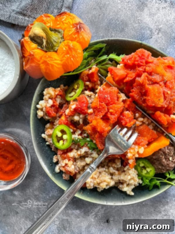 Unstuffed Pepper Soup 10 A single stuffed bell pepper in a white bowl, garnished with herbs.