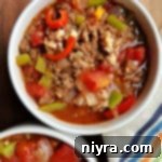 Unstuffed Pepper Soup 13 Two bowls of hearty Stuffed Pepper Soup, garnished with fresh parsley.