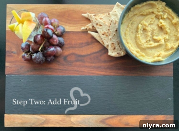 Step two of building a Mediterranean Cheeseboard: adding fruits