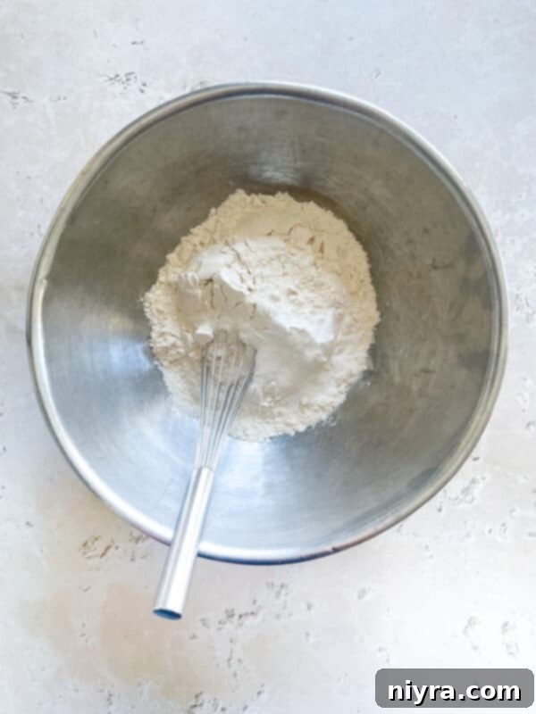 Sweet Cherry White Chocolate Delights 9 Mixing dry ingredients for white chocolate cherry cookies in a small bowl
