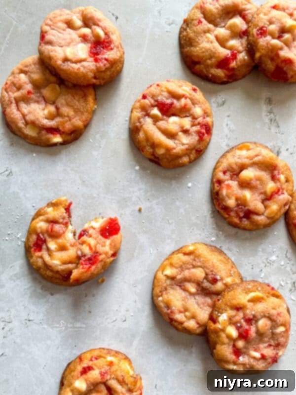 Sweet Cherry White Chocolate Delights 14 White Chocolate Cherry Cookies stacked on a white plate, ready to be enjoyed