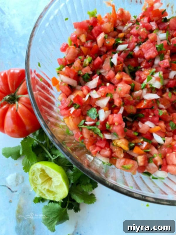 Fresh Tomato Salsa 2 Close-up of fresh Pico de Gallo in a glass bowl, garnished with cilantro.