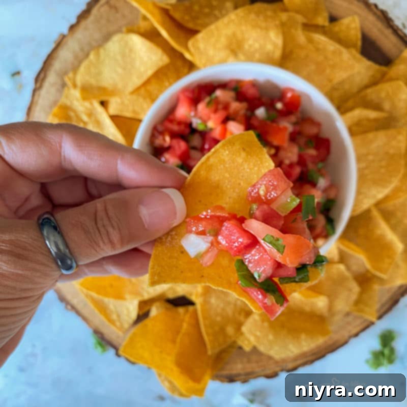 Fresh Tomato Salsa 8 Adding fresh lime juice to the Pico de Gallo mixture in a bowl.