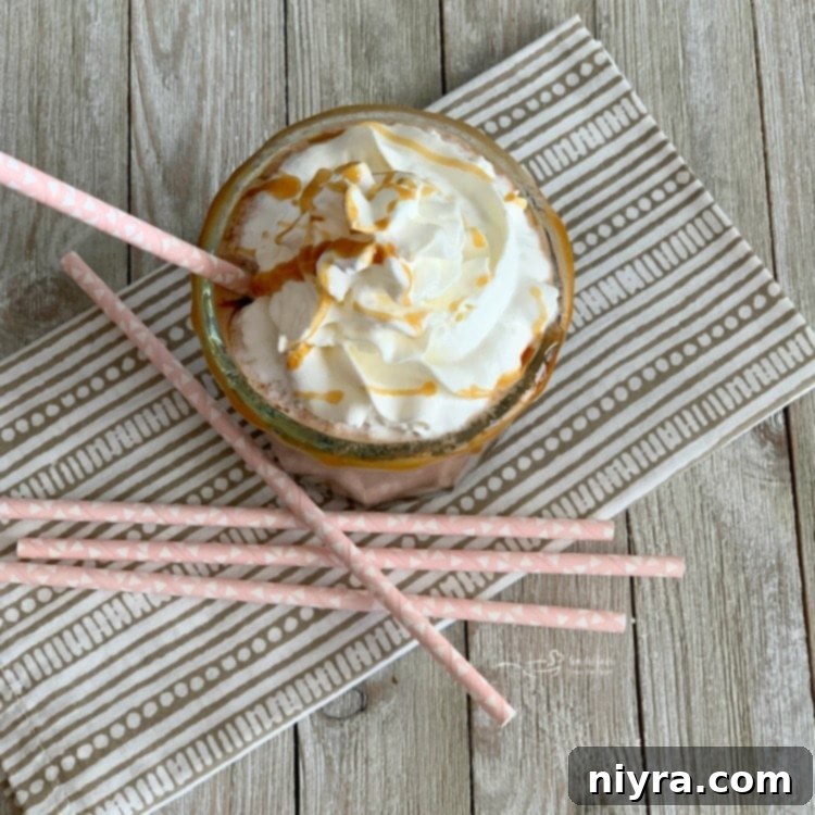 Salted Caramel Mocha Blended 6 Close-up view of a Salted Caramel Mocha Smoothie with an abundance of whipped cream and caramel topping