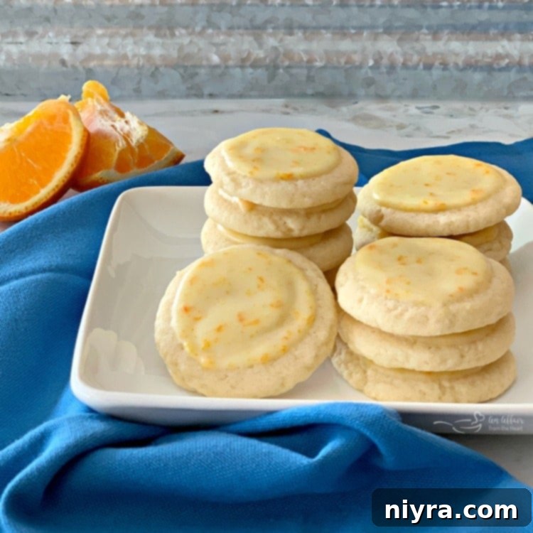 Bright and refreshing Orange Meltaway Cookies stacked on a plate