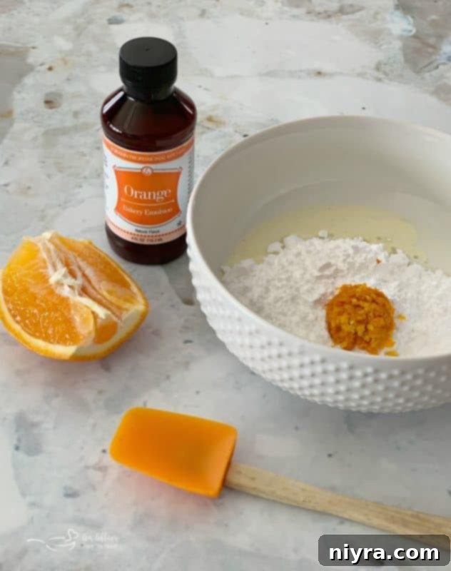 Ingredients being prepared for Orange Meltaway Cookies, including a bottle of LorAnn Orange Bakery Emulsion