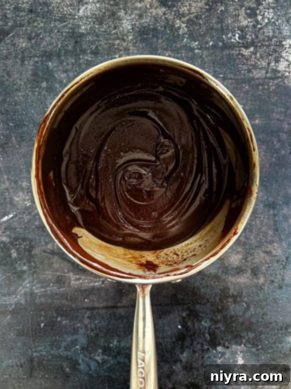Baked strawberry donuts cooling on a wire rack.