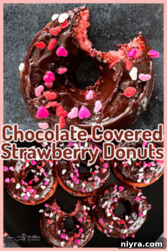 A festive display of chocolate covered strawberry donuts on a tiered serving tray.