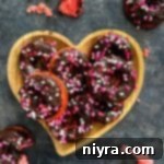 Chocolate Covered Strawberry Donuts stacked in a hearty shaped platter.