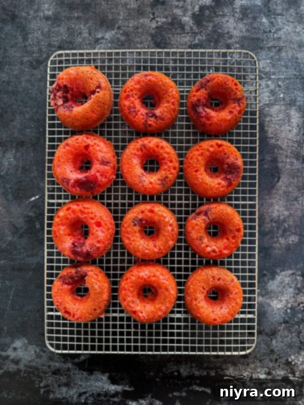 Baked strawberry donuts fresh out of the oven in a donut baking pan.