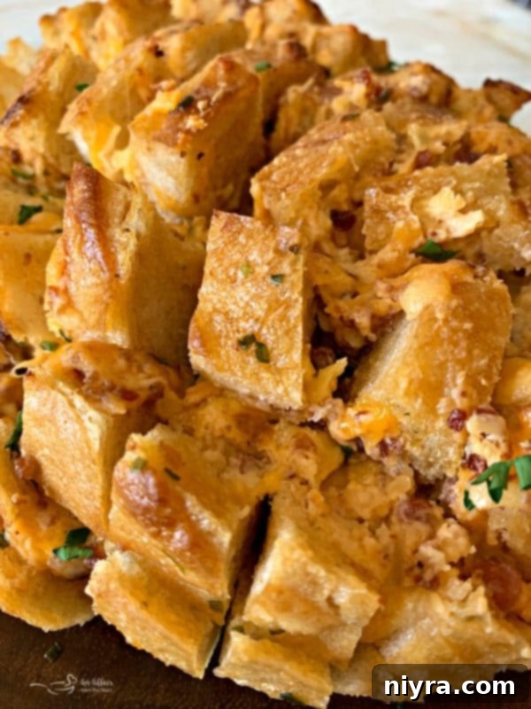 Detailed view of the cheese and bacon filling within the cracked sourdough bread