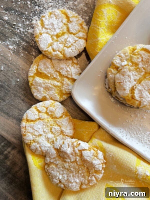 Lemon Crinkle Cookies arranged on a yellow plate