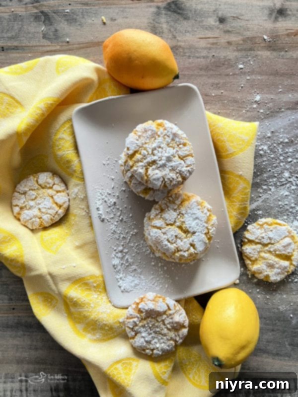 Lemon Crinkle Cookies artfully arranged with fresh lemons