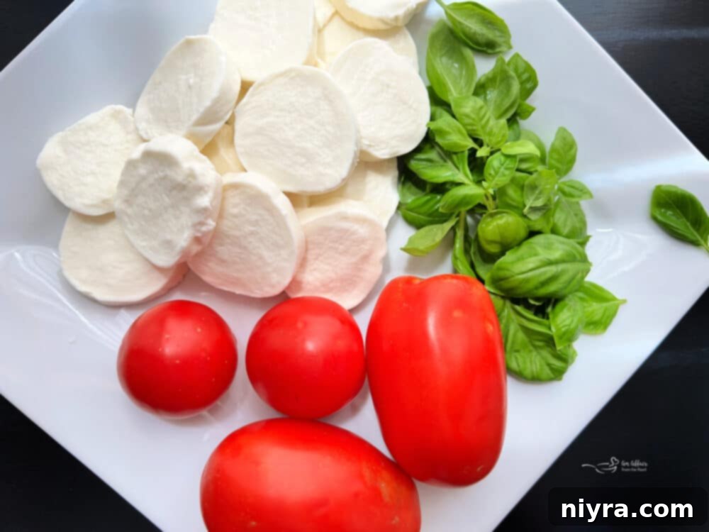 Artfully arranged Caprese salad with whole basil leaves