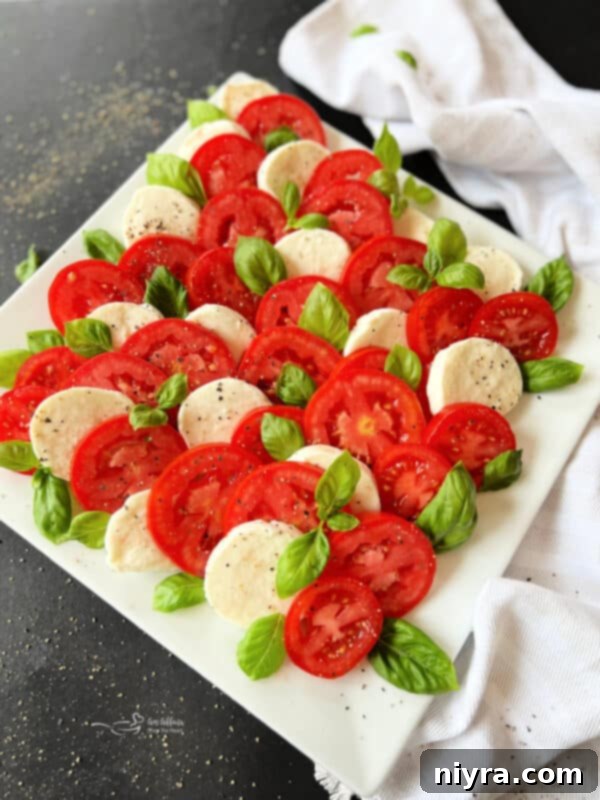 Sprinkling salt and pepper on Caprese salad