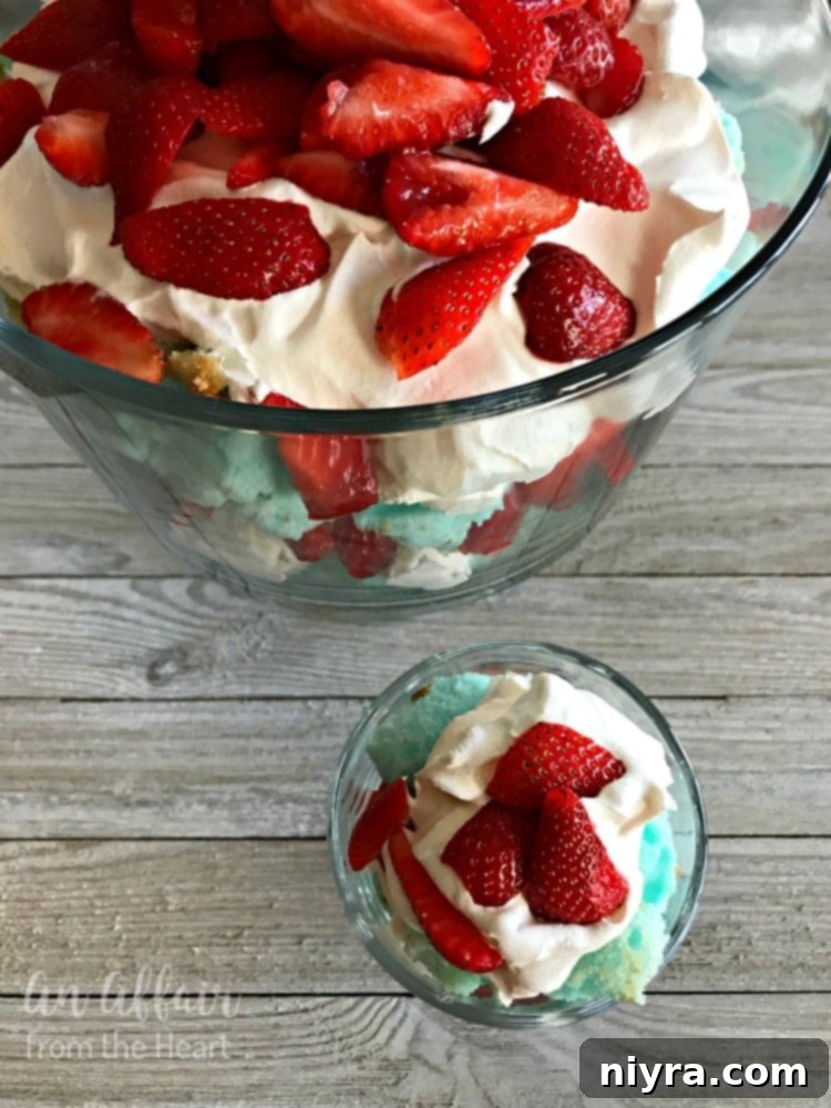 Red, White and Blue Strawberry Shortcake Trifle in a clear glass bowl, ready for serving