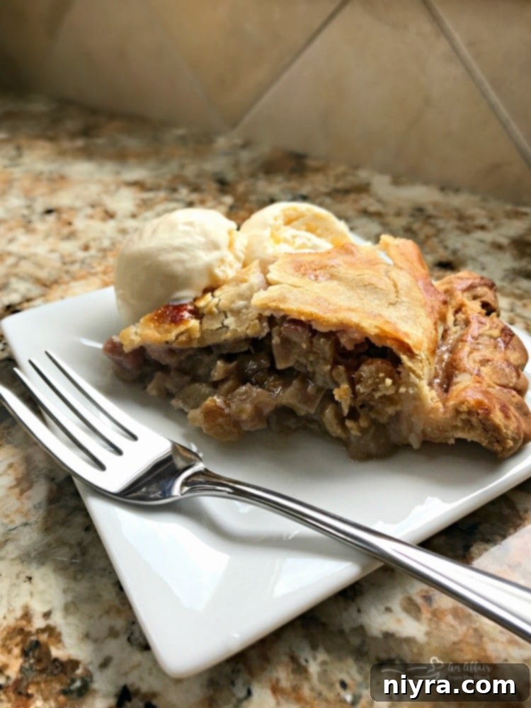 Old-Fashioned Rhubarb Pie 3 Grandma's Rhubarb Pie on a white plate with a fork