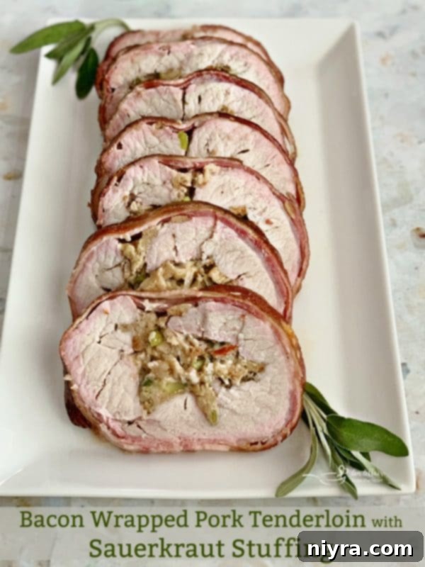 Perfectly sliced Bacon Wrapped Pork Loin with Sauerkraut Stuffing on a white platter, showcasing the beautiful layers.