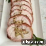 Bacon Wrapped Pork Tenderloin on white platter