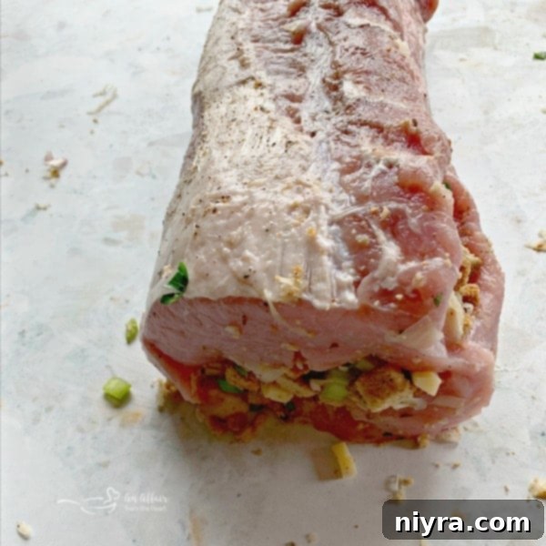 Rolled pork tenderloin, securely holding the sauerkraut stuffing inside.