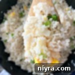 Close up of Homemade Basic Garlic Fried Rice on a wooden spoon