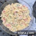 Hearty Spam Pasta Salad 13 Overhead shot of a clear bowl filled with delicious Spam Pasta Salad.