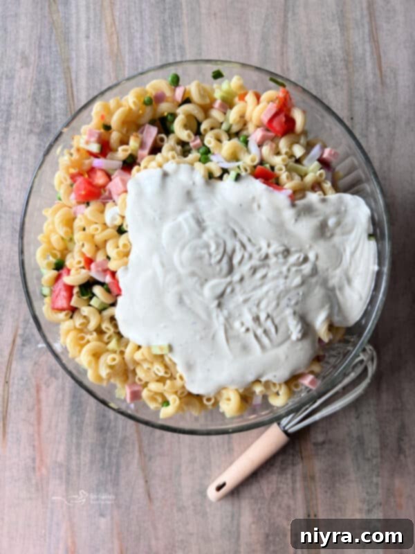 Hearty Spam Pasta Salad 8 Chopped vegetables and diced Spam are added to the cooked pasta in a large bowl.