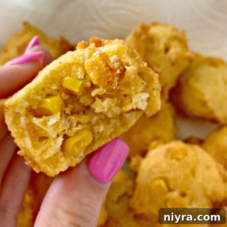Close-up of corn fritters showing the sweet corn kernels inside.