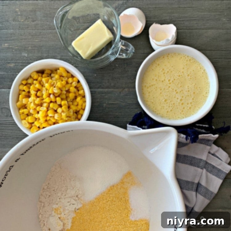 Ingredients for corn fritters being mixed in a bowl.