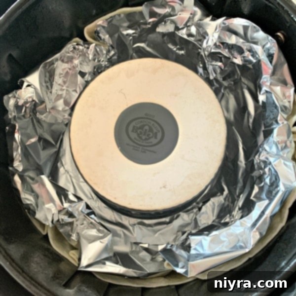 Step 3: Shaping tortilla in air fryer basket with foil and ramekin