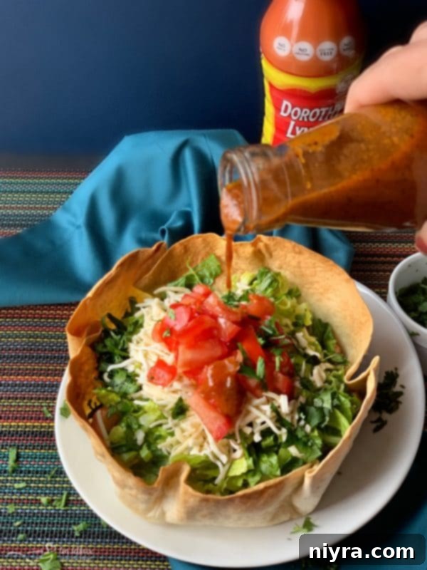 Close-up of Dorothy's Taco Salads topped with dressing and cilantro.