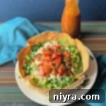 Taco Salad on a white plate and Dorothy Lynch Taco Sauce