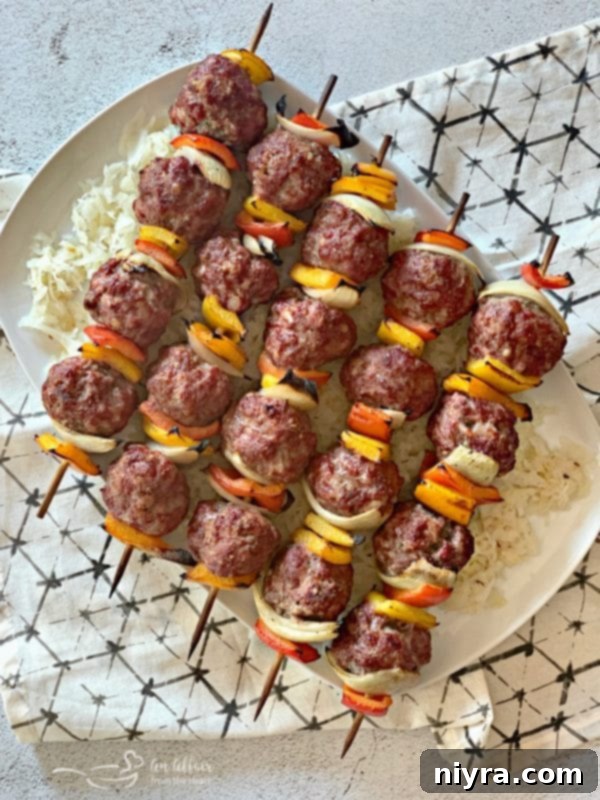 Grilled Bratwurst & Kraut Meatball Kabobs with vibrant peppers and onions