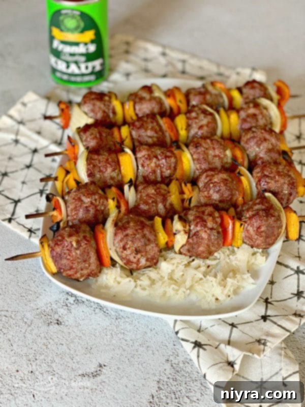 Grilled Bratwurst & Kraut Meatball Kabobs plated over warm Frank's Kraut with caraway seeds