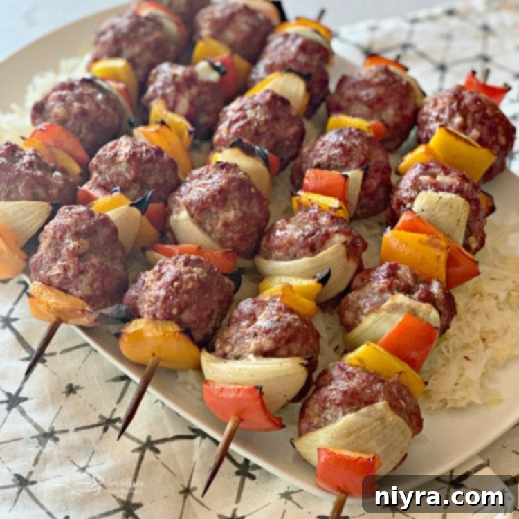 Skewered Bratwurst and Kraut Meatball Kabobs with colorful vegetables