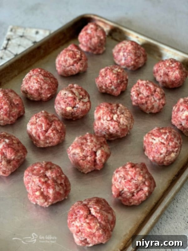 Formed bratwurst and kraut meatballs on a tray