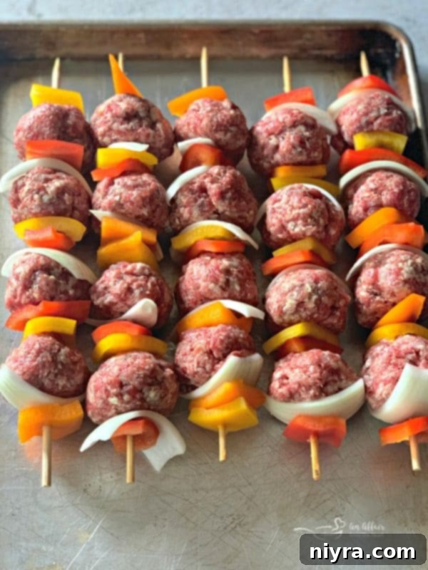 Assembled Bratwurst and Kraut Meatball Kabobs on skewers