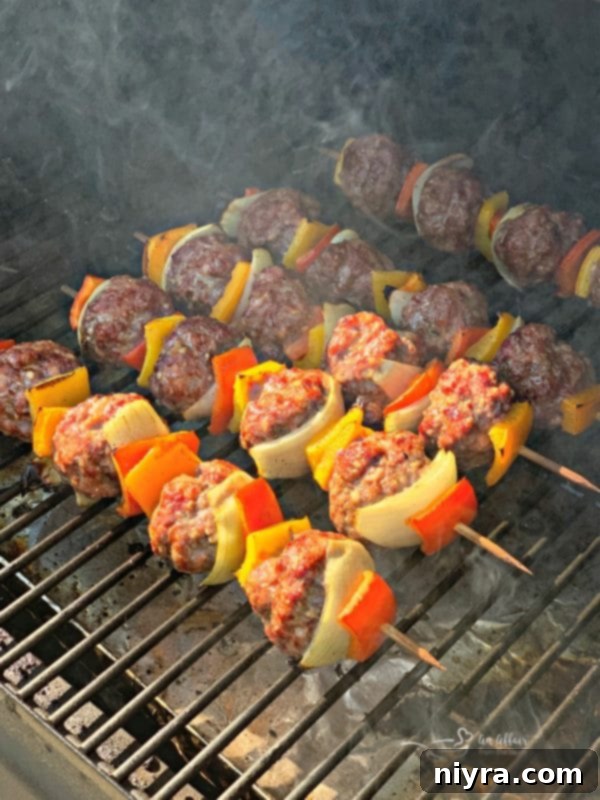Bratwurst and Kraut Meatball Kabobs cooking on the grill
