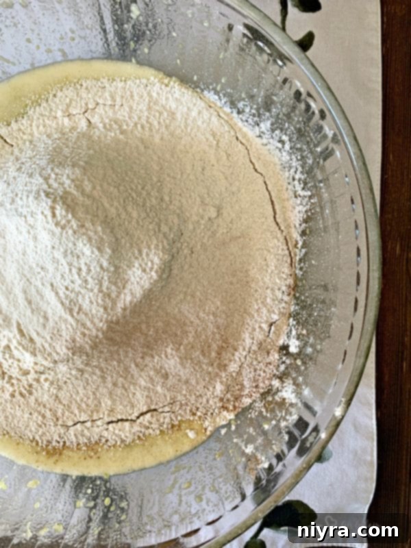 Combining wet and dry ingredients for Zucchini Bread batter